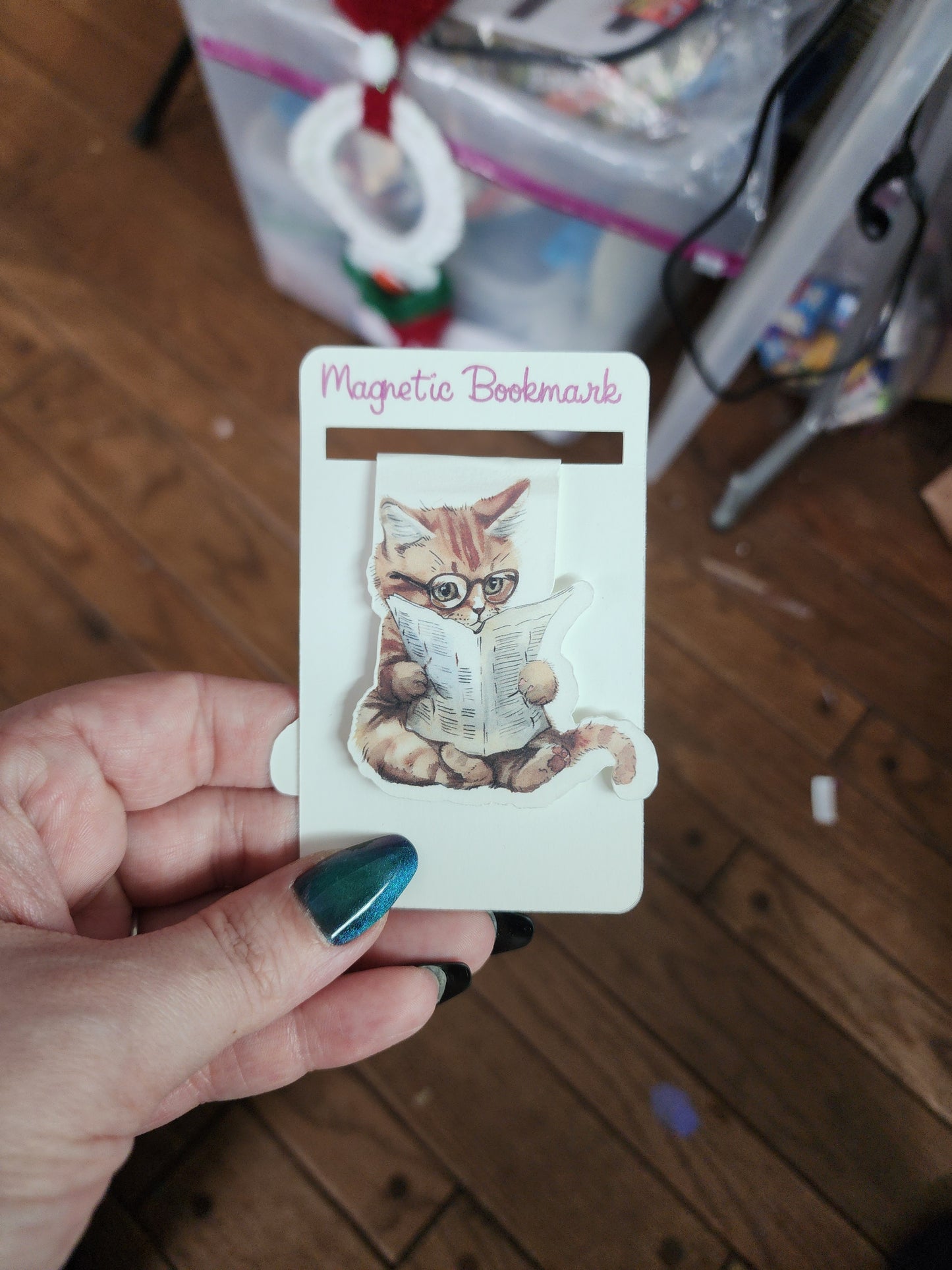 Cat with a paper magnetic bookmark